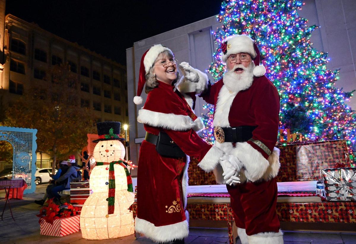 Santa dances with Mrs. Claus in front of the lit tree as the Downtown Fresno Partnership’s second annual Christmas Tree Lighting ceremony was held at Mariposa Plaza along Fulton Street on Friday.