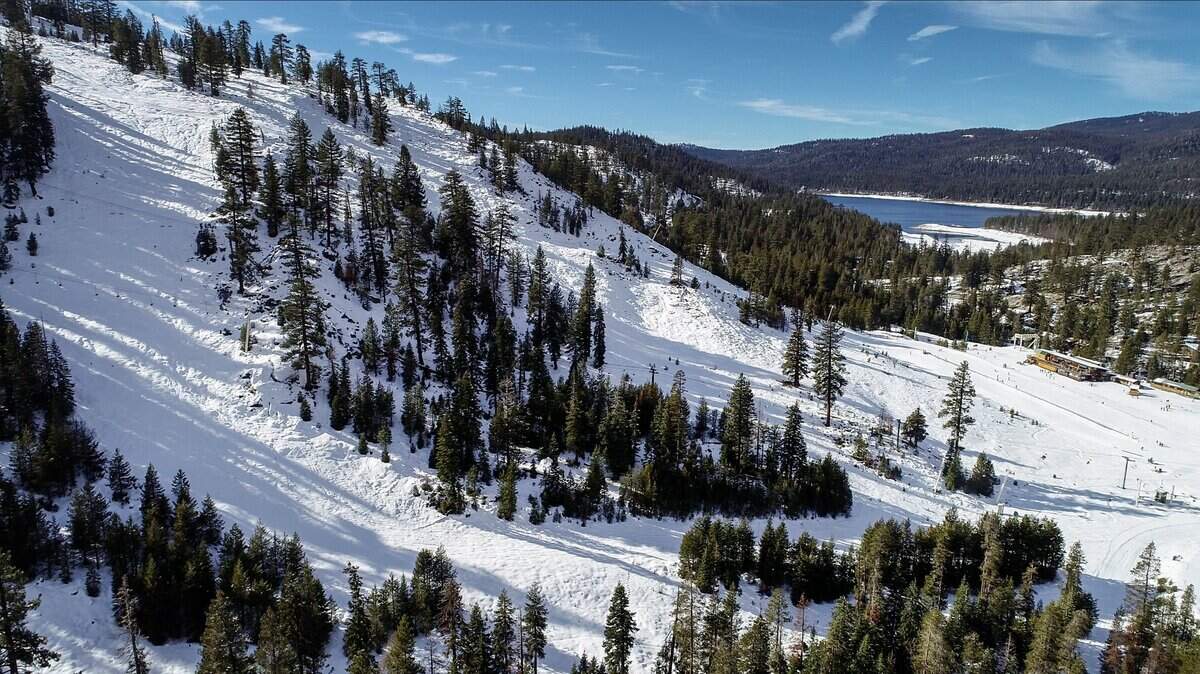 Huntington Lake is visible in the background as the ski runs show signs of an increasing snow pack at China Peak Mountain Resort in this December 2018 photo.