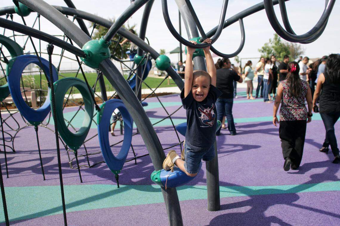 A boy plays in the playground during 2008 rededication of Rojas-Pierce Park in Mendota in October 2008.