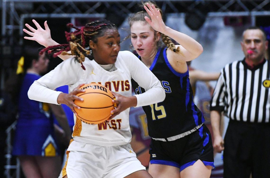 Clovis West’s Etoyah Montgomery, left, with Clovis High’s Devin Miller in the background in the Central Section girls Division I basketball championship Saturday, Feb. 25, 2023 in Fresno.