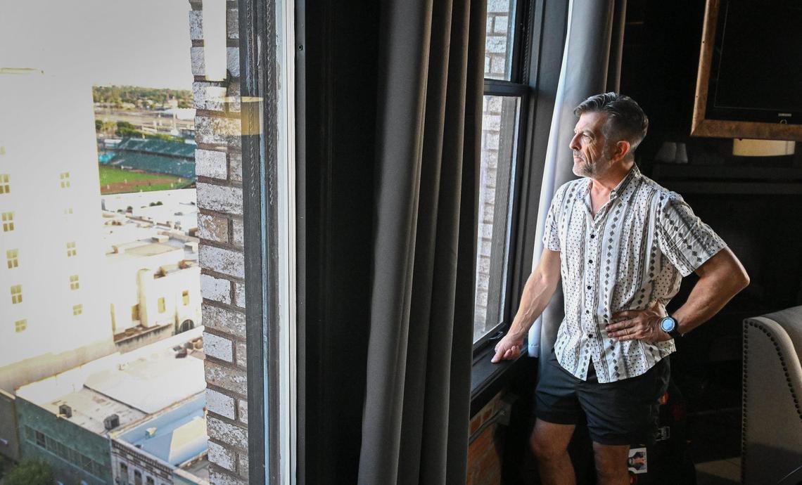 Steve Skibbie, who came to Fresno from Oregon for college, looks out the window of his apartment in the Pacific Southwest Building in downtown Fresno on Tuesday, June 10. 2025.