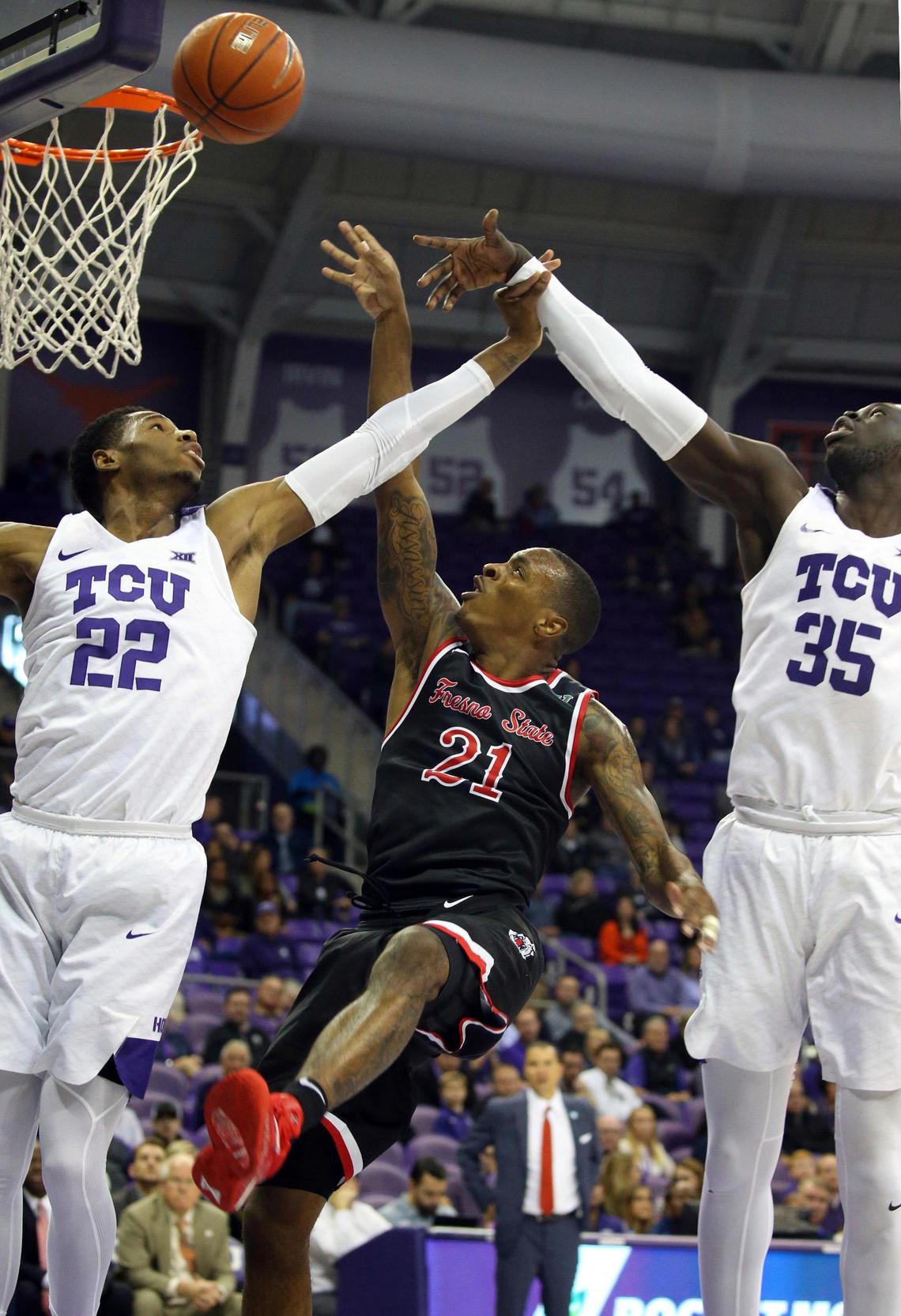 Fresno State guard Deshon Taylor (21) gets an off-balance shot up and over TCU guard RJ Nembhard (22) and TCU forward Yuat Alok (35) in the Bulldogs’ 77-69 loss to the Horned Frogs Thursday, Nov. 15, 2018, in Fort Worth, Texas. Taylor had 13 points, four rebounds and three assists for the Bulldogs.