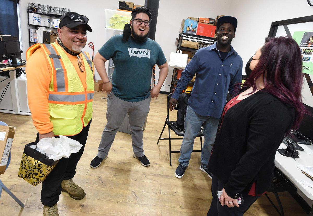 Rochelle Trujillo, coordinator of the CEO (Center for Employment Opportunities) program, left, and staff members Christian Govea, second from left, Christopher Williams, second from right, joke with Shane Lara, former site supervisor, left, on his last day of employment with CEO.