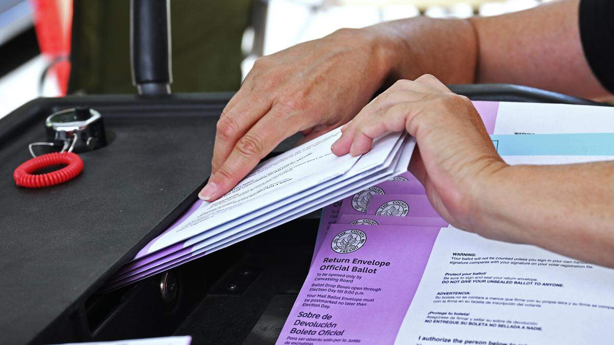 Ballots are placed into a collection box by election workers outside the Fresno County Clerk/Election office Tuesday, June 2, 2026 in downtown Fresno.