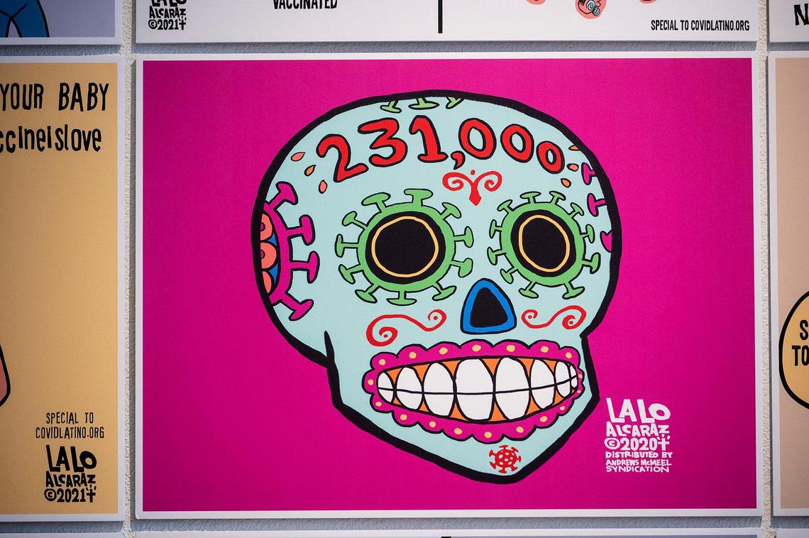 Artwork by political cartoonist Lalo Alcaraz is displayed at the Merced Multicultural Arts Center in downtown Merced, Calif., on Thursday, Oct. 28, 2021. In celebration of Dia de los Muertos, Cultiva La Salud-Merced County will open an art exhibition containing pieces by Alcaraz created for the COVIDLatino.org project.