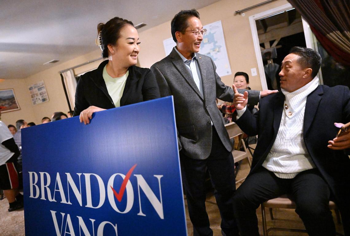 May Lee, left, stands alongside her husband Fresno City Council District 5 candidate Brandon Vang, center, as he and supporters gather waiting for the results of the special runoff election Tuesday night, March 18, 2025 in Fresno.