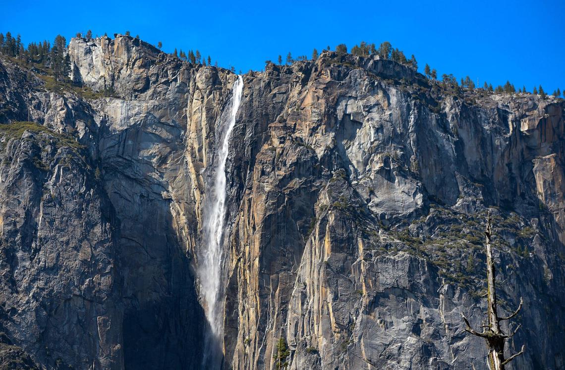 A surge of springtime runoff rushes over Ribbon Fall just west of El Capitan on the western edge of Yosemite Valley in Yosemite National Park on Friday, April 23, 2021.