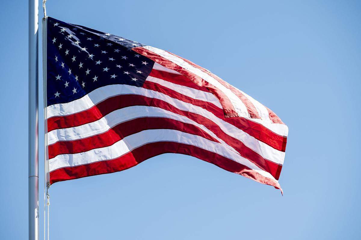 An American flag is raised inside the Castlewood community during a ceremony in Atwater, Calif., on Tuesday, June 14, 2022. According to Castlewood resident Sharon Wilkerson, the American flag was raised on the communitys new flag pole as a way to pay tribute to families who lived in former Castle Air Force Base housing as well as fallen soldiers.