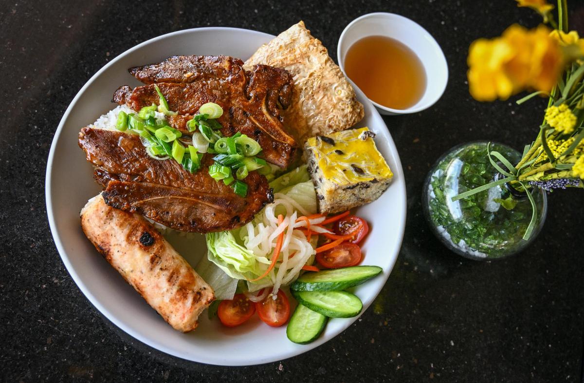 The Saigon broken rice grilled pork chop platter with shrimp paste sugar cane stick, shrimp cake and egg meatloaf served at Sizzle n’ Steam in central Fresno.