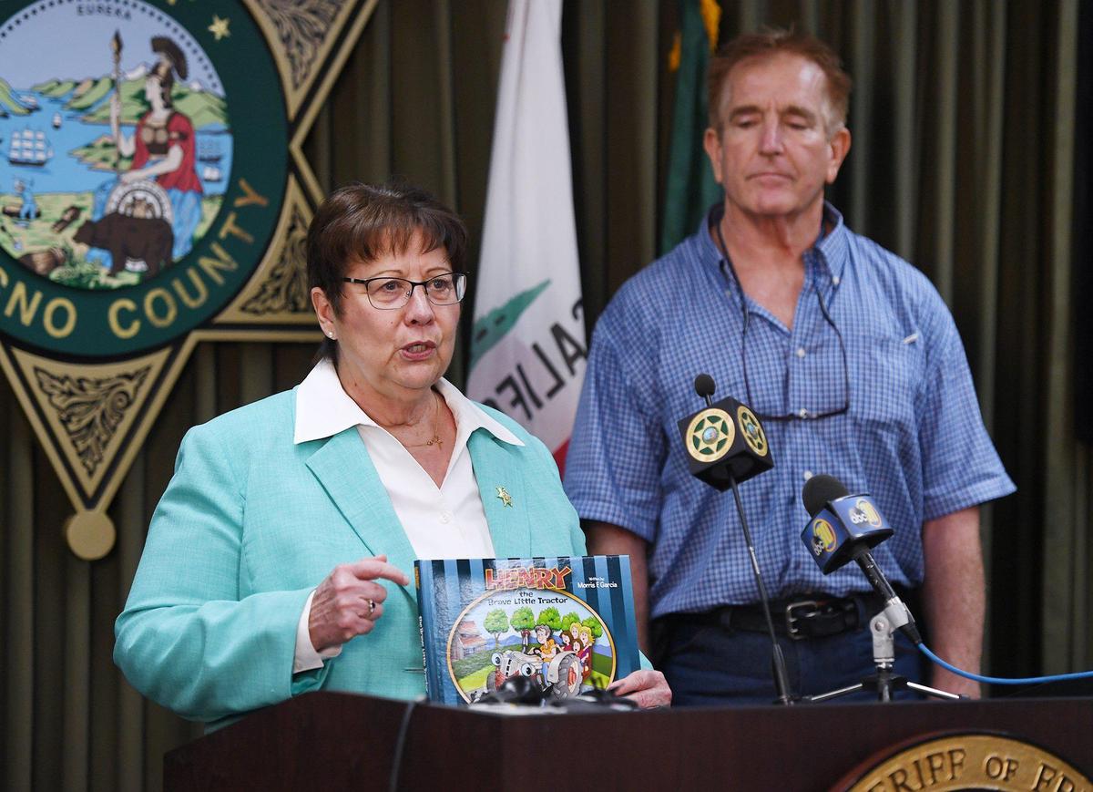 Fresno County Sheriff Margaret Mims describes how late author Morris Garcia’s children’s book will help the Sheriff’s Reading Posse program. Garcia’s son, Kevin, was on hand to donate 100 copies Monday, Aug. 9, 2021 in Fresno.