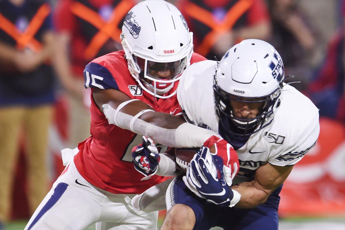 Fresno State linebacker Arron Mosby, left, breaks up a pass intended for Utah State’s Caleb Repp, Saturday, Nov 9, 2019 in Fresno. The Aggies kicked a field goal as time expired to come away with a 37-35 victory.