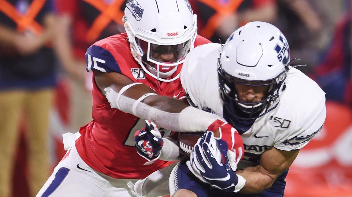 Fresno State’s Arron Mosby, left, breaks up a pass intended for Utah State’s Caleb Repp, right, Saturday, Nov 9, 2019 in Fresno. The Aggies led the Bulldogs 21-14 at haltime.