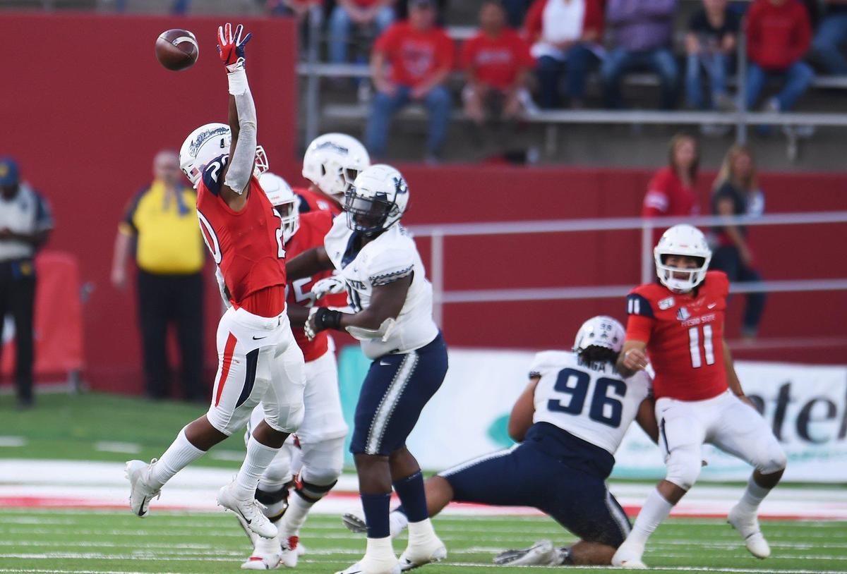 Fresno State quarterback Jorge Reyna, far right, overthrows Ronnie Rivers, far left, against Utah State Saturday, Nov 9, 2019 in Fresno. Reyna hit 16 of 20 passes for 263 yards in the Bulldogs’ 37-35 loss.