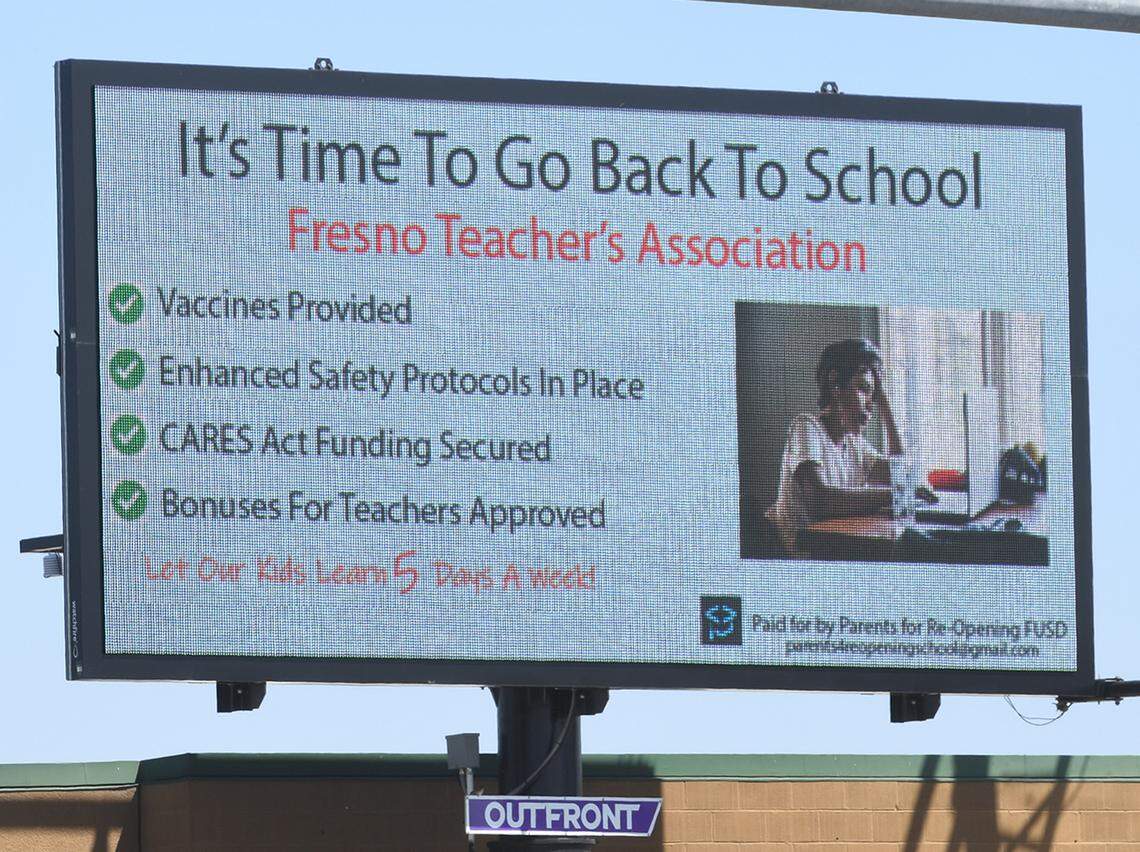 One of two signs on an electronic billboard funded by Parents for Reopening Fresno Unified at one of the busiest intersections in the city, Shaw and Blackstone, on April 1, 2021, with their message to reopening Fresno Unified schools five days a week for all grade levels K-12.&nbsp;