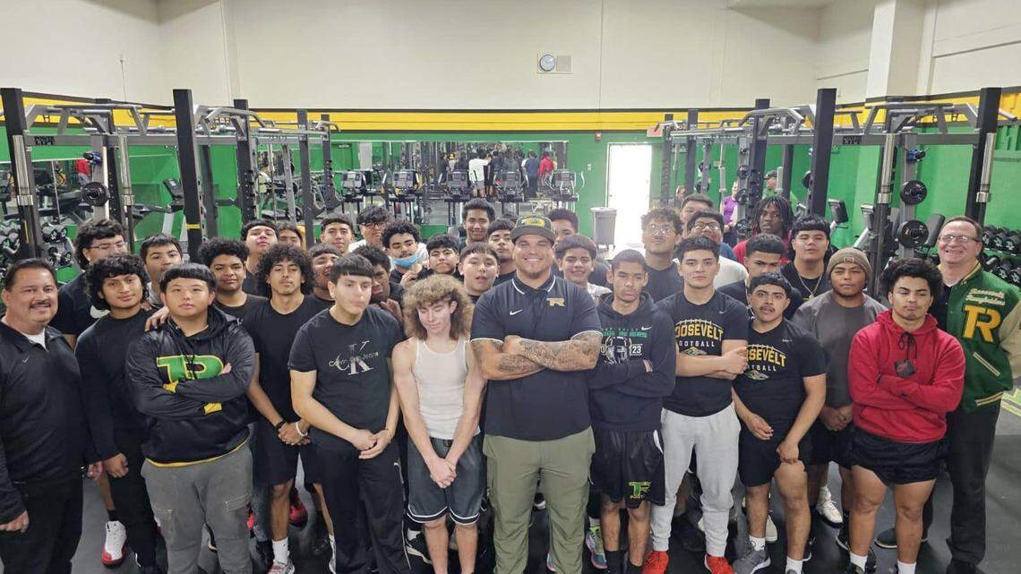 Ricky McCoy, middle, was named the Roosevelt High football coach in January 2024.