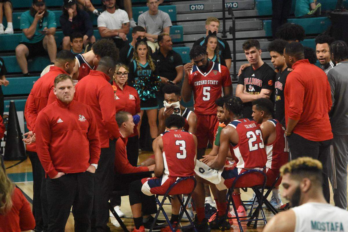 Fresno State coach Justin Hutson takes the Bulldogs through a timeout during am 85-74 victory over Coastal Carolina in the championship game of The Basketball Classic in Conway, S.C. The Bulldogs won a national postseason tournament since taking the 1983 NIT.