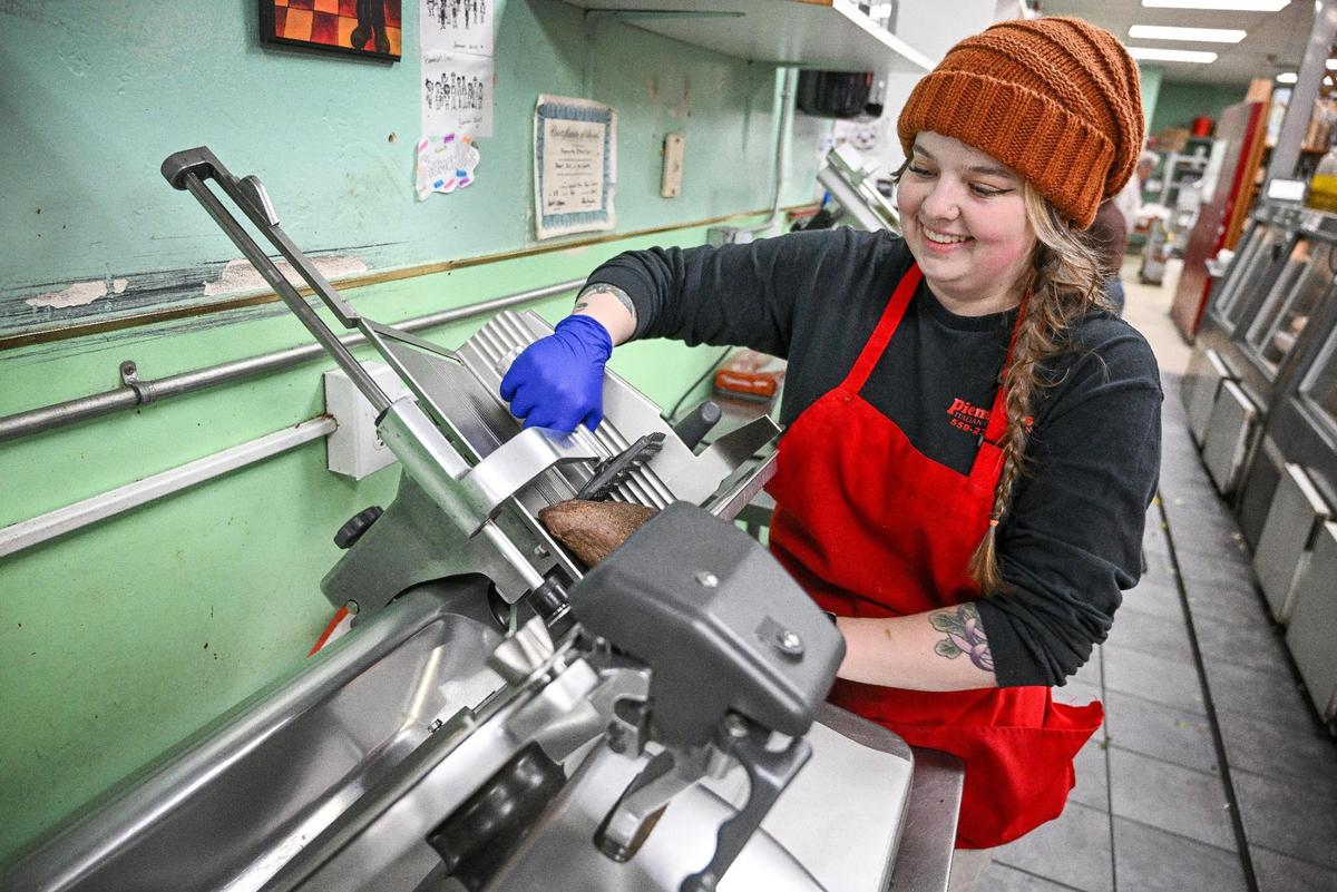 Piemonte’s Deli manager Madison Lindsey Martinez slices deli meat during the lunchtime rush on Thursday, Jan. 9 2025. Lindsey Martinez, who, with her mother Jules, is in the process of purchasing the Tower District deli and will run it much the same.