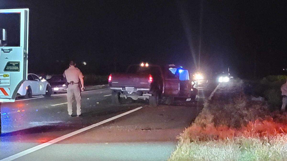 A CHP officer investigates a fatal two-vehicle crash on Highway 180 west of Fresno, California, on Friday night, April 15, 2022.