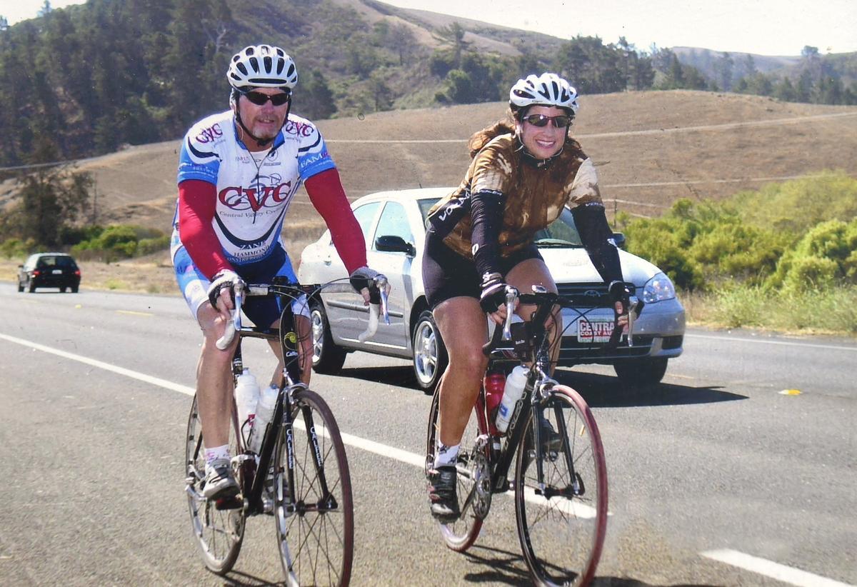 A photograph of Bill Griffith, left, riding alongside his wife Alicia Haro during the Lighthouse Century. Alicia, who had MS, died in 2016.