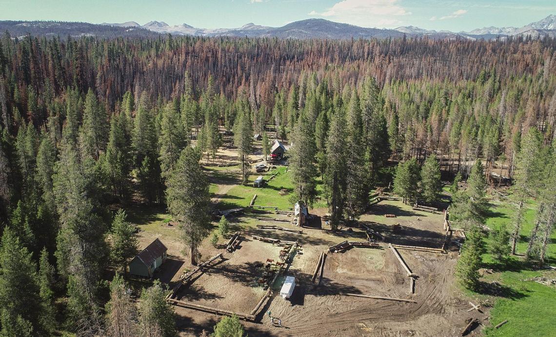 Blackened areas of forest trees in the background show how close the Creek Fire came to the Minarets Pack Station in the Sierra National Forest last year as seen in this drone image on Friday, June 11, 2021. Despite some damage from the fire and recent Mono wind events, the owners of the pack station are opening for business this summer.