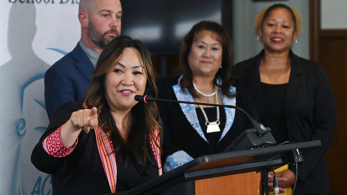 Deputy Superintendent Misty Her, left, points to where she once sat early in her career as she introduces herself as Fresno Unified’s incoming Interim Superintendent at a press conference held Wednesday, May 8, 2024 in Fresno. Current Superintendent Bob Nelson is stepping down effective July 31 for a tenure track faculty position at Fresno State.