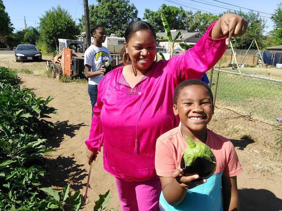 Maria Else, Freedom School Demonstration Farm President, jokes with child in the program, in an undated photo. She passed away June 25, 2020.
