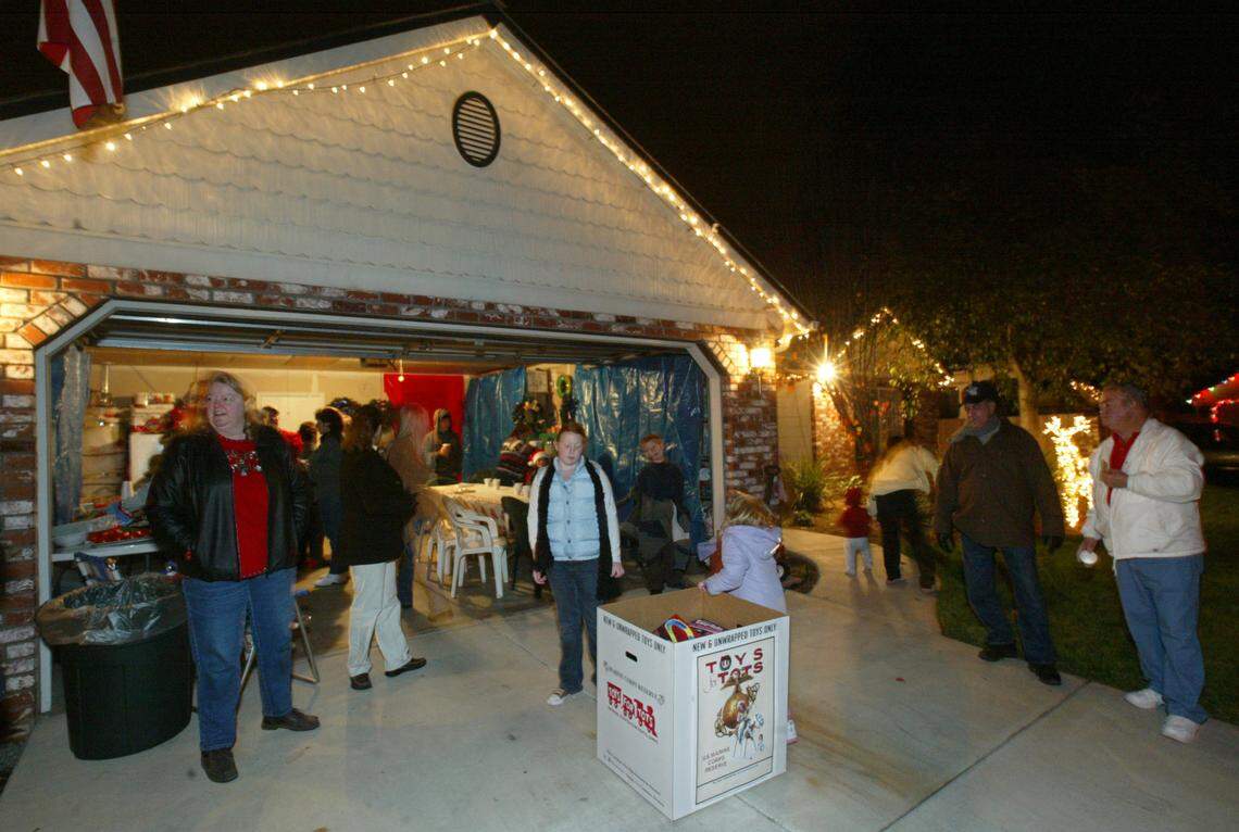 Lodi neighborhood residents gather at Sue and Lee Harralson’s house during the neighborhood’s first annual Christmas Walk on the Block party.