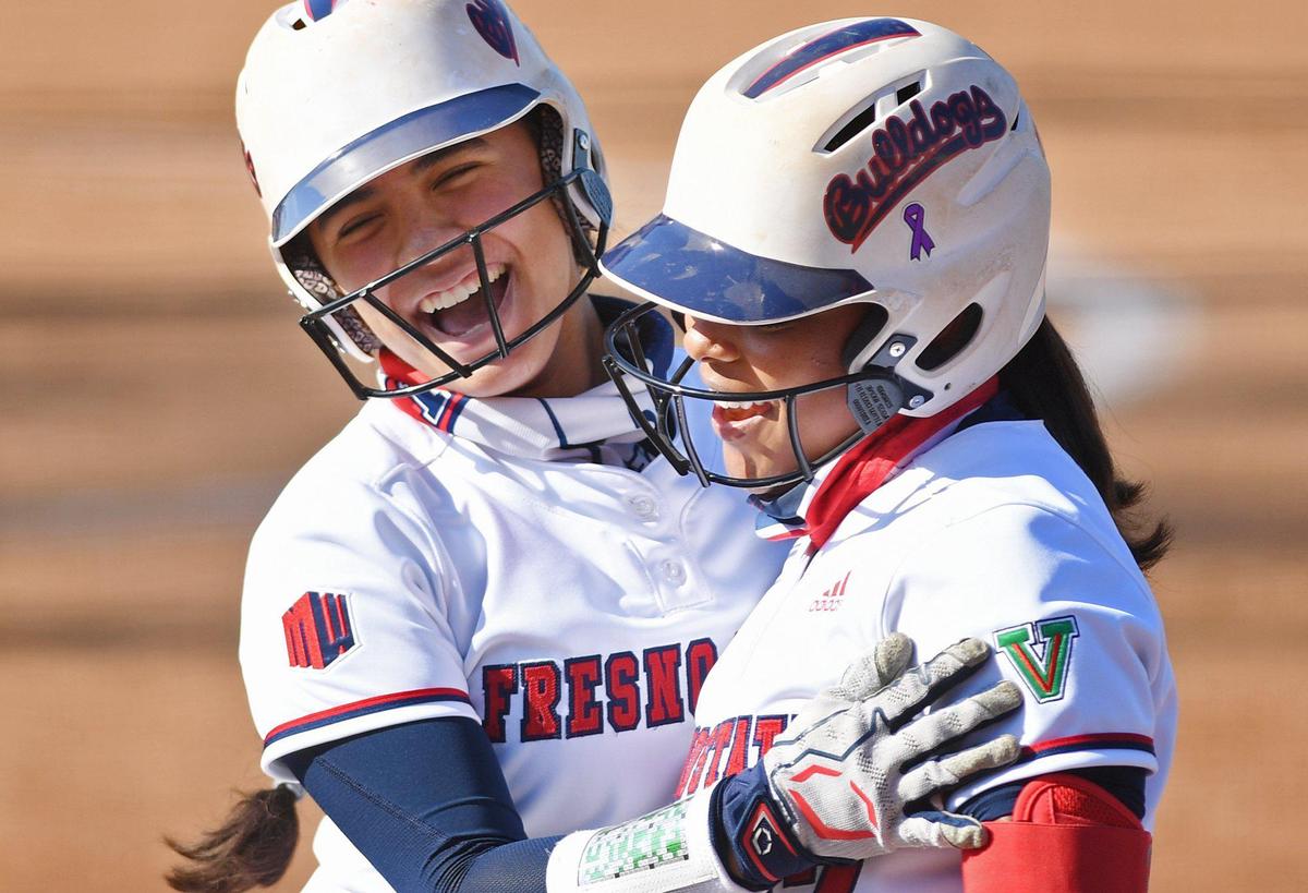 Fresno State’s Alexandra Preston, right, celebrates a home run by Keahilele Mattson, left, against Pacific in the first game of a doubleheader Friday afternoon, Feb. 19, 2021, at Margie Wright Diamond in Fresno. The game ended in the fifth inning with a 9-0 Bulldogs win.