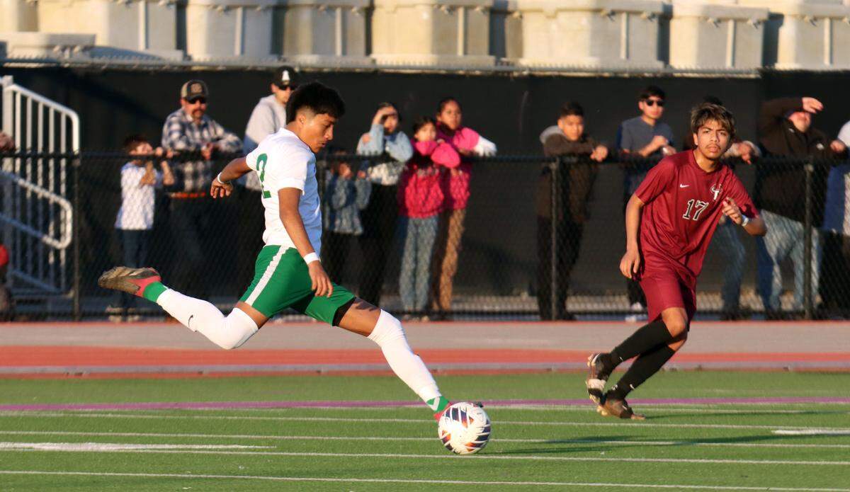 Riverdale High senior Felipe Mora fires the ball past Matilda Torres High defender Ángel Villagomez during the CIF Central Section Division V championship at Madera South on Feb. 24, 2024. Torres won, 1-0.