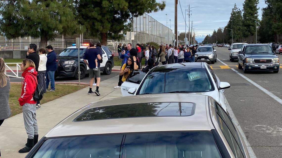 Relatives of students wait outside Clovis West High School in Fresno, California, on Friday, Feb. 3, 2023, after the campus was locked down due to the threat of a shooting.
