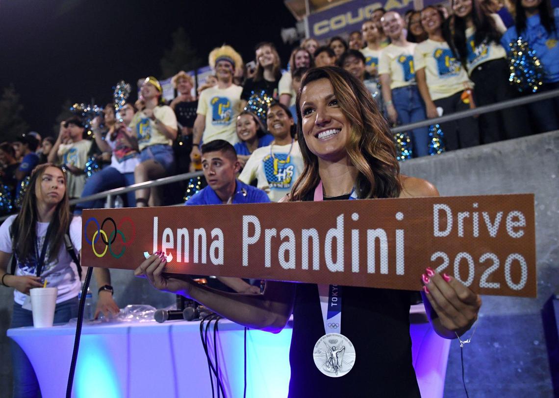 Olympic silver-medalist and Clovis High alum Jenna Prandini holds a street sign dedicated to her in a ceremony at halftime between the Clovis and Bakerfield game Friday, Aug. 27, 2021 in Clovis.