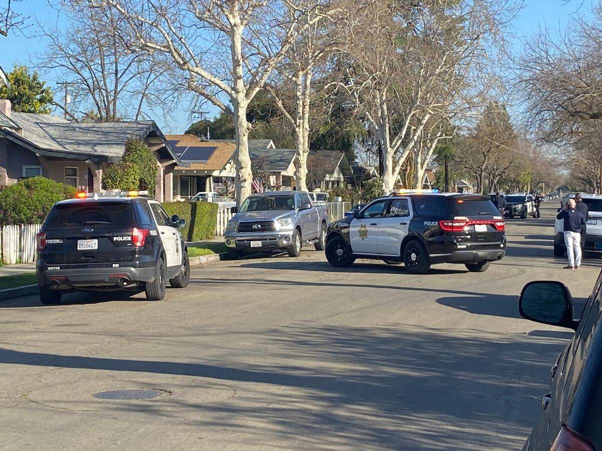 Fresno police were outside a Tower District home on Friday, March 17, 2023, calling for a man to come out on the same block where a handyman was shot earlier in the morning, according to police.