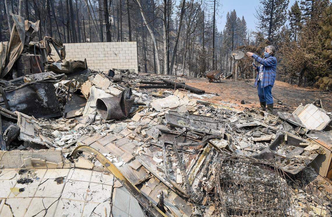 Gloria Sprague looks over the damage to her home on Auberry Road near Alder Springs on Tuesday, Sept. 22, 2020. Residents who lost their homes in the Creek Fire were being allowed to return to survey the damage and salvage any items.
