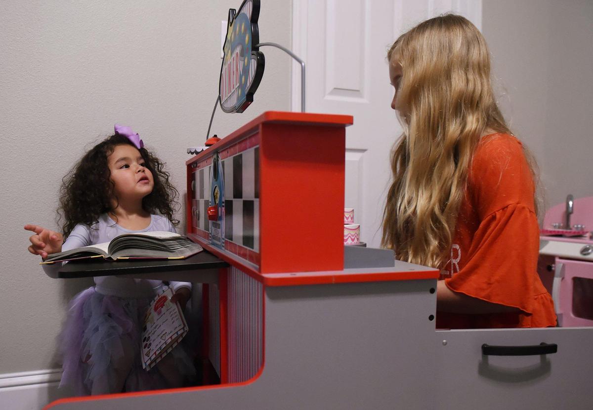 Finley Tenison, 3, left, plays with her big sister Emma in the family’s playroom Thursday, Jan. 23, 2020 in Fresno. Finley, who had heart surgery at birth to correct transposition of the greater arteries, is this year’s Kids Day ambassador.