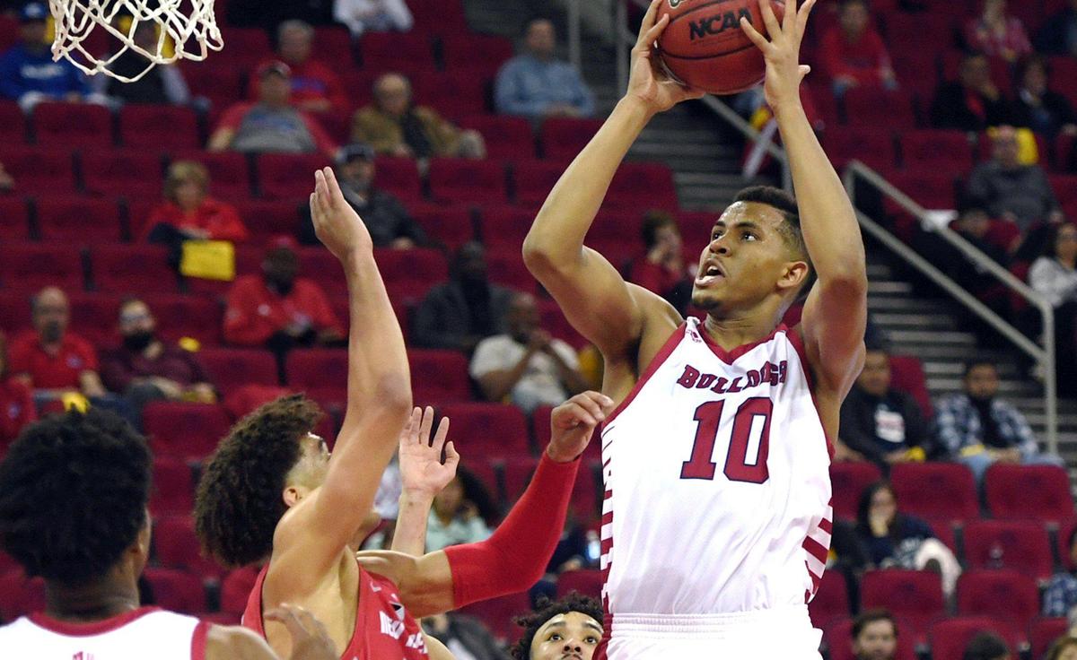 Fresno State’s Orlando Robinson, goes up for two covered by1 New Mexico’s Javonté Johnson, center, on the way to a 71-68 win over New Mexico Monday, Feb. 28, 2022 in Fresno.