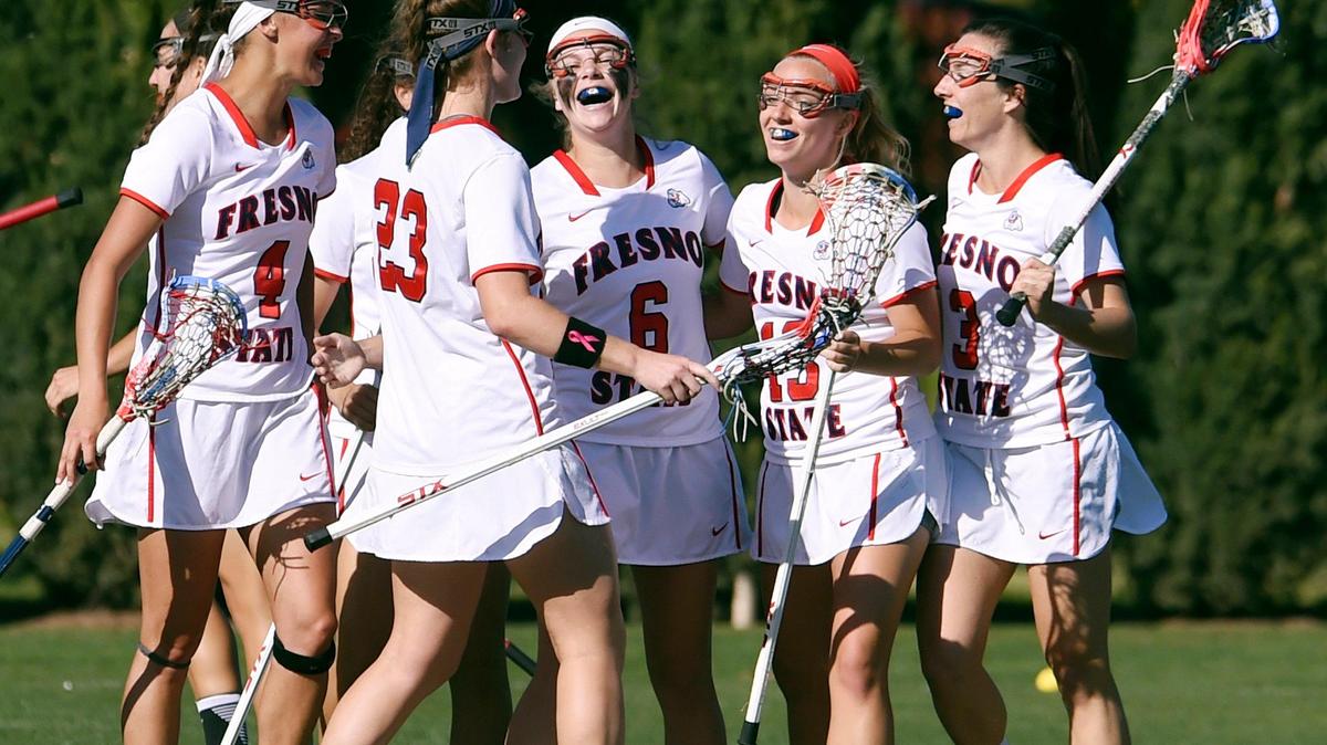 The Fresno State women’s lacrosse team celebrates after scoring a goal against San Diego State in 2017. The program is under investigation and faces an uncertain future, playing in a three-team conference that has made no commitment beyond a 2020 season..