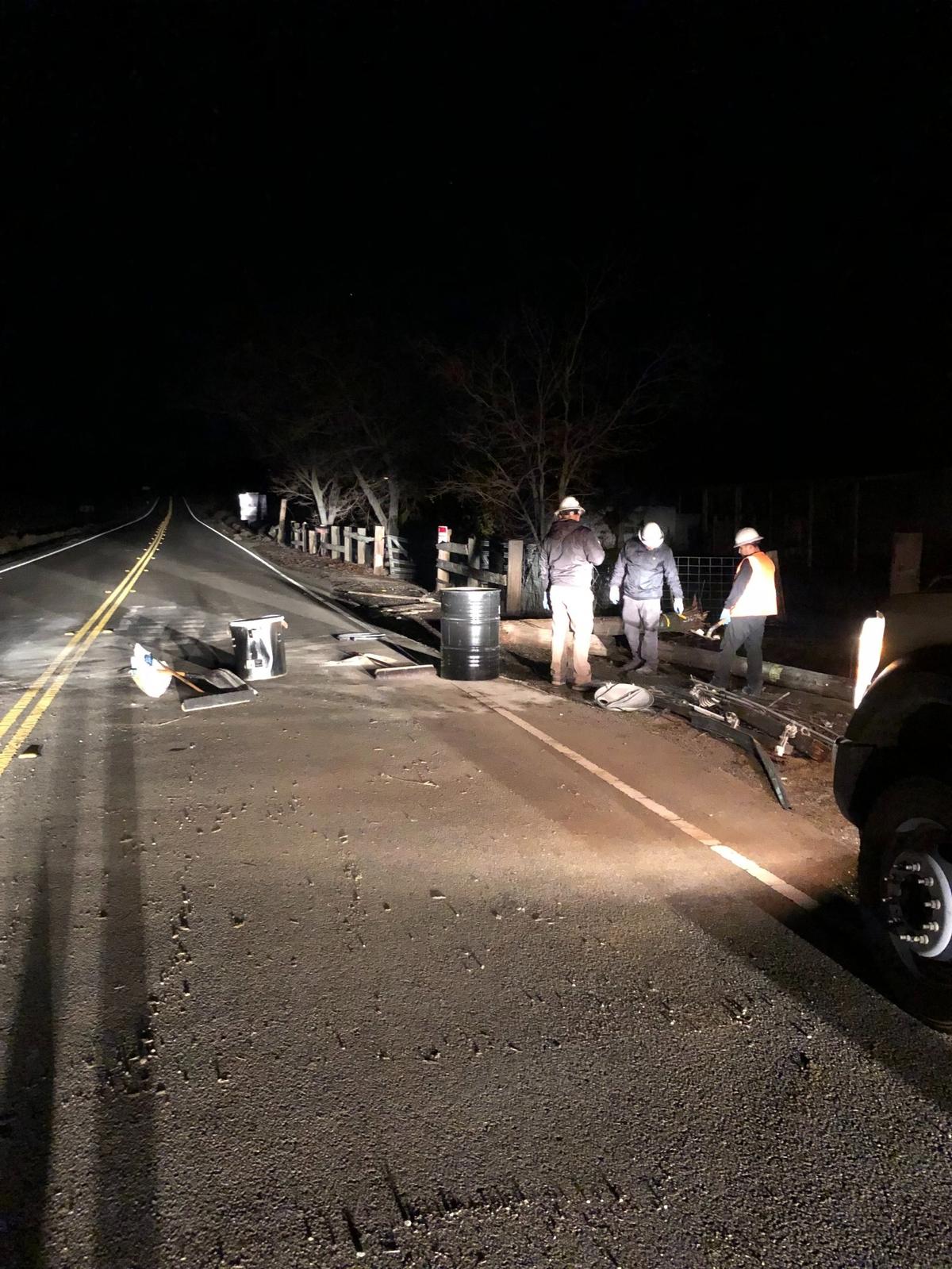 Crews look to clear the road after a power pole fell after a non-injury crash near Millerton Lake on Thursday, Dec. 15, 2022.