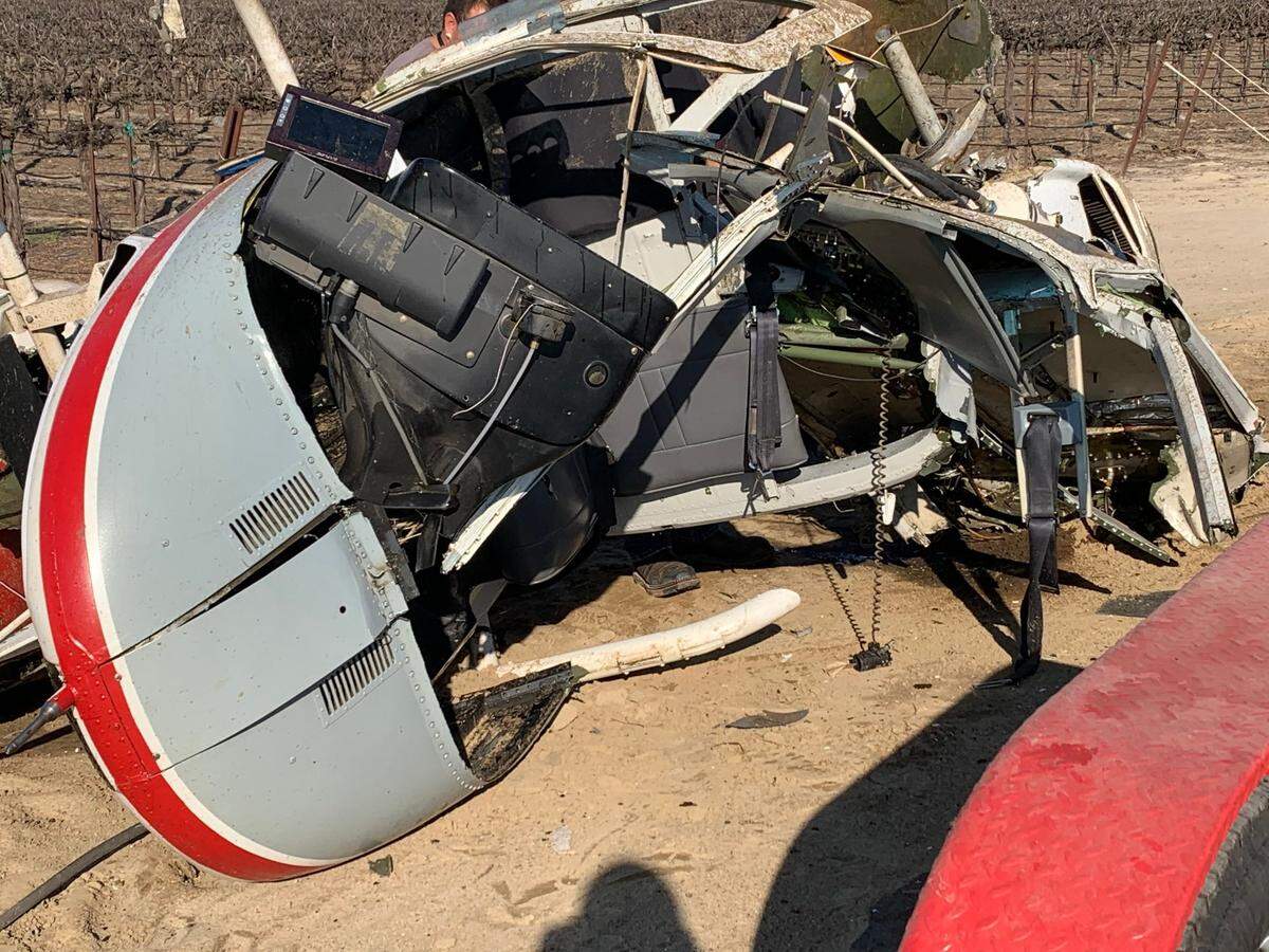 Wreckage is seen after a helicopter clipped power lines while spraying a field near Laton in Fresno County, California on Saturday, March 13, 2021.