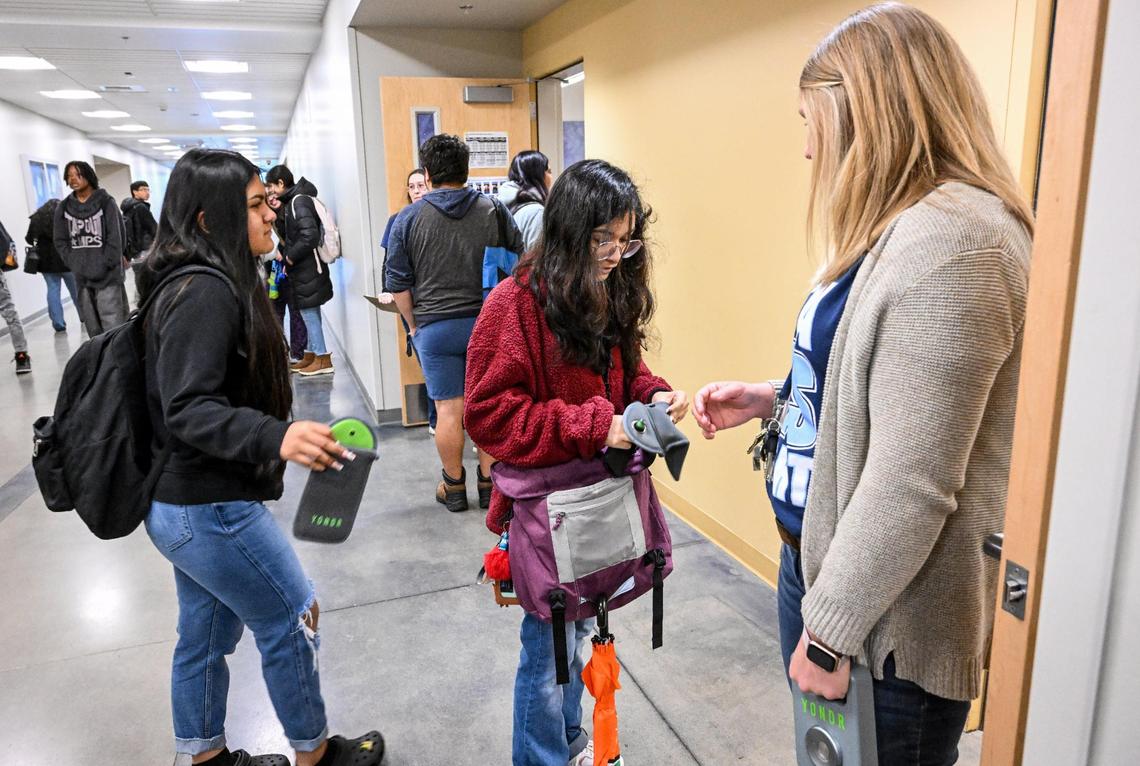 Bullard High School Algebra 1 teacher Tiffanie Alarcon checks students’ Yondr pouches before they enter her classroom on Monday, Jan. 22, 2024. Students at Bullard must store their cell phones in the pouches where they stay locked inside until after the school day ends when they can be unlocked with a magnetic device.