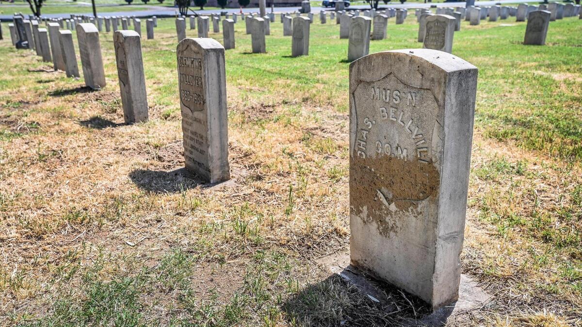 A veterans headstone is shown caked in mud at the Veterans Liberty Cemetery on Belmont Avenue near Hughes in Fresno on Friday, April 28, 2023.