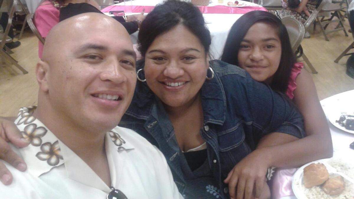 In happier times, Fresno County correctional officer Taomalama Scanlan, left, wife Tepatasi Scanlan, middle, and daughter Melania pose for a photograph. Taomalama Scanlan was severely injured in a September 2016 shooting at the county jail in downtown Fresno and remains in recovery.