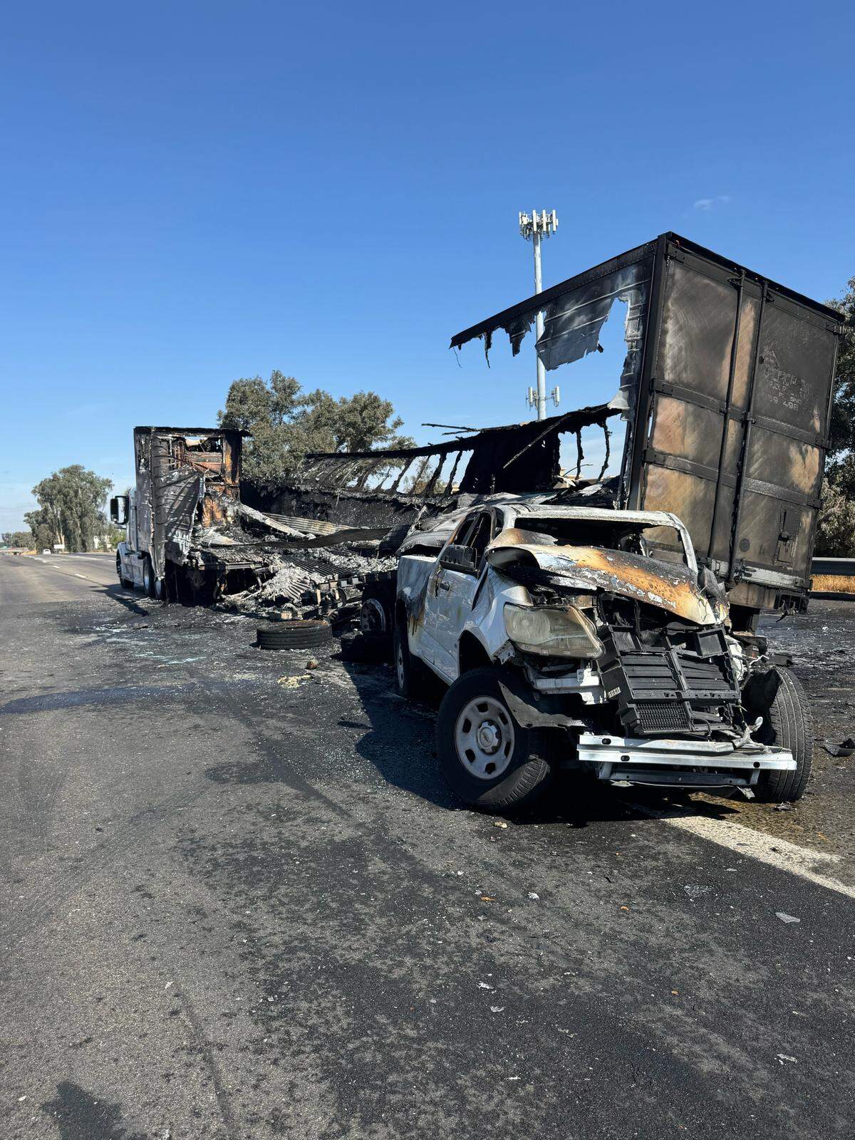 The aftermath of a fiery crash between two vehicles and a trailer on Highway 99 at Herndon in Fresno, California on Tuesday, Sept. 9, 2025.