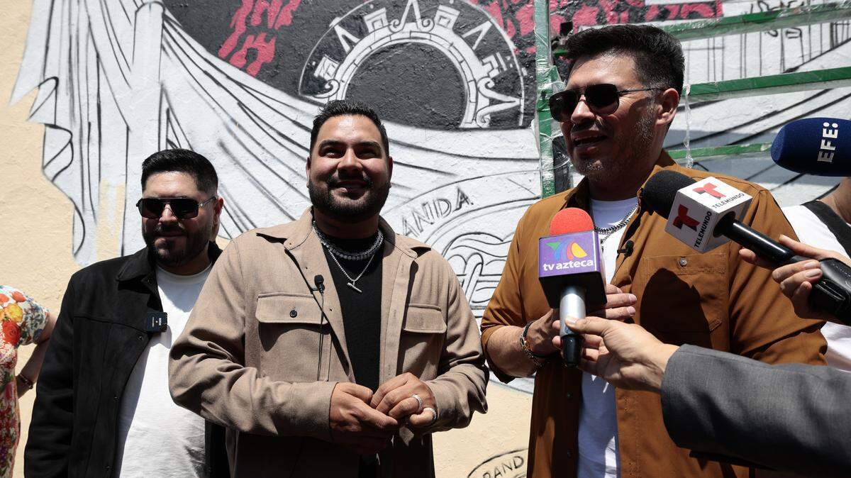 Los integrantes de la Banda MS, Alan Ramírez, Oswaldo Silvas y David Castro hablan durante la inauguración de un mural dedicado a la agrupación en Ciudad de México. El grupo de música regional mexicana Banda MS celebra este 2024 dos décadas encima de los escenarios y con la energía “del primer día”, según expresó Silvas en una entrevista.