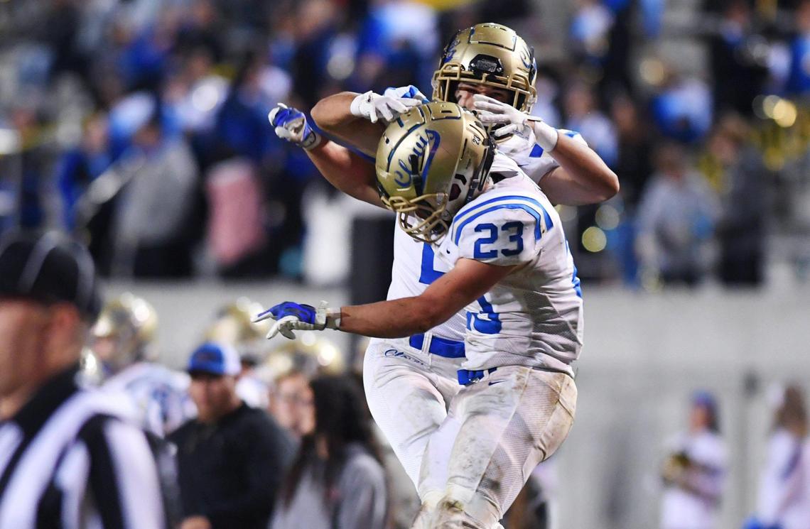 Clovis High’s Tyler Marquez, background, celebrates Roman Moreno’s touchdown, foreground, making it 6-0 against Clovis West in first quarter action of a central Section DI quarterfinal Thursday, Nov. 10, 2022 in Clovis.