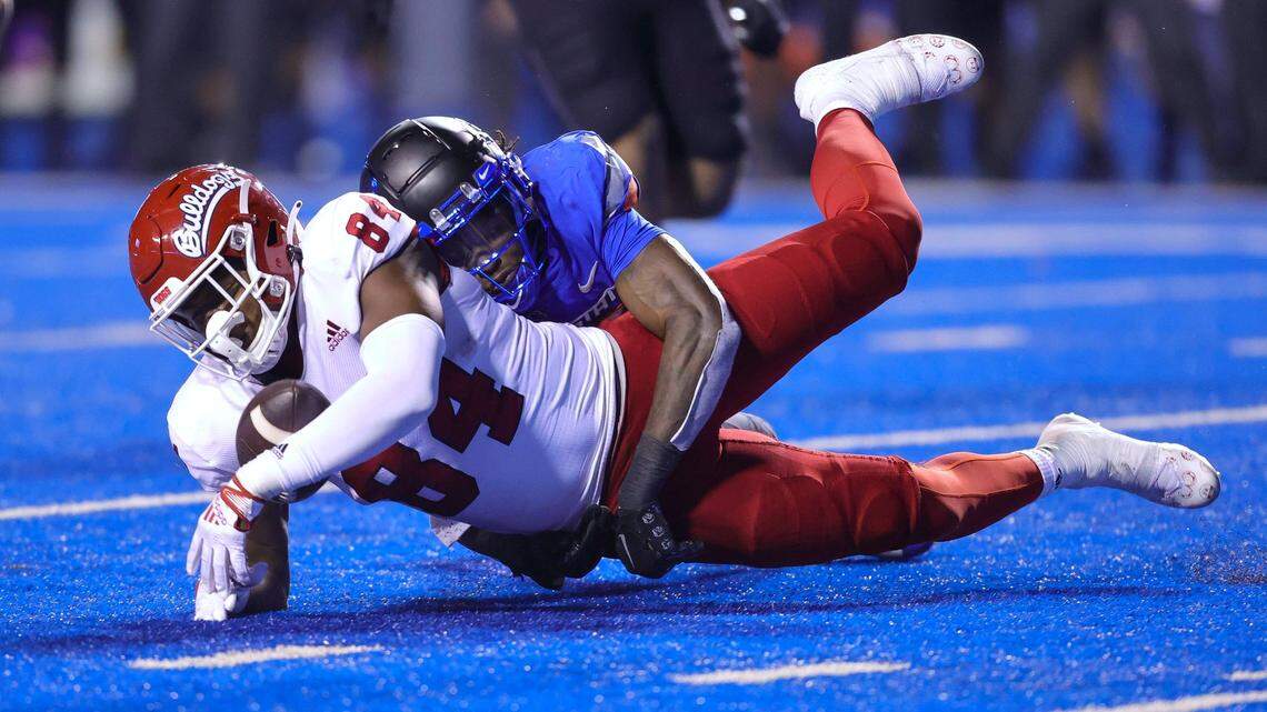 Fresno State tight end Tre Watson (84) is unable to hang on to the ball for an reception as he is tackled by Boise State cornerback Tyreque Jones (21) during the second half of an NCAA college football game, Saturday, Oct. 8, 2022, in Boise, Idaho. Boise State won 40-20. (AP Photo/Steve Conner)