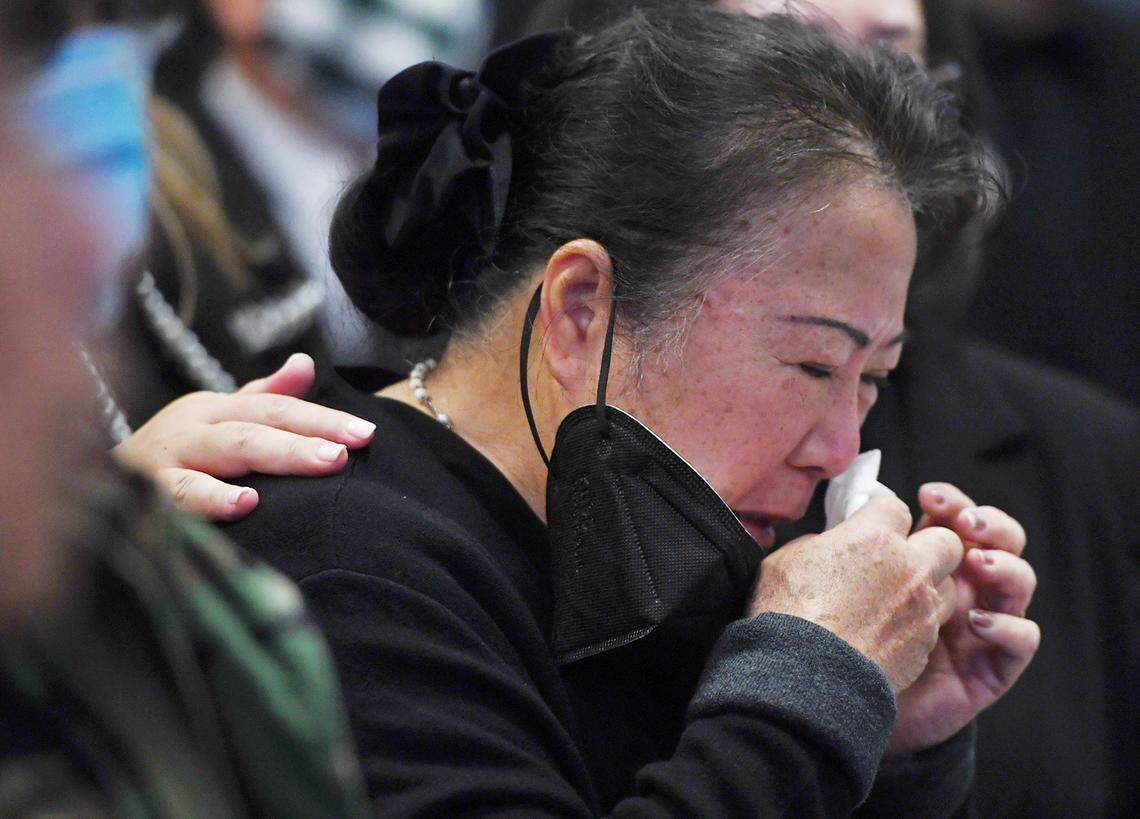 Mai Lee Vang, widow of Col. Wangyee Vang, Ph.D, is consoled as the service begins for her husband Saturday morning, March 13, 2021 in Fresno. Vang was the leader of the National Lao Hmong veterans group and served in the U.S. Secret Army during the Vietnam War.
