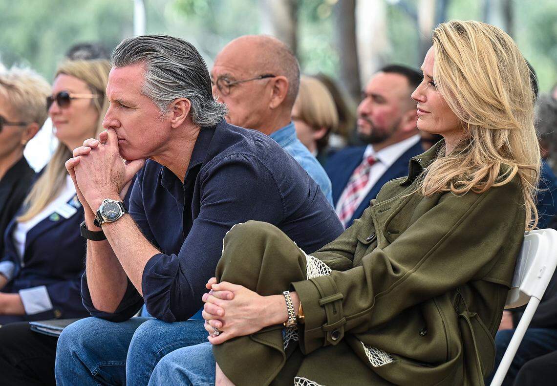California Gov. Gavin Newsom and his wife, first partner Jennifer Siebel Newsom, listen to speakers before he announced the expansion of the state park system during a news conference near the Sycamore Island fishing dock along the San Joaquin River Parkway in Madera County on Wednesday, April 22, 2026.