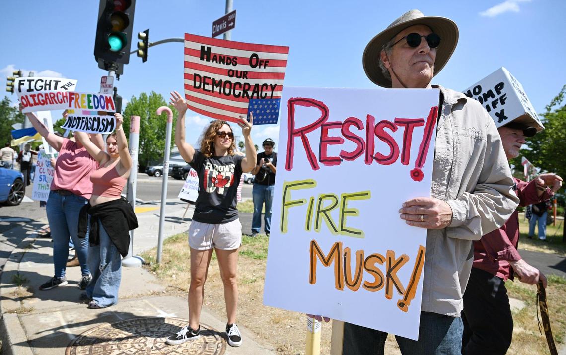 Clovis’ Jeff Adolph, right, stands at Shaw and Clovis avenues for a Hands Off rally Saturday, April 19, 2025 in Clovis.