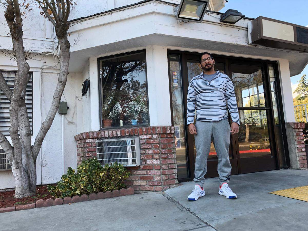 Pratike Bhakta, 31, stands in front of the Motel 6 that his family operates on Parkway Drive near downtown Fresno. Bhakta and other business owners say a city ordinance requiring motel upgrades for long term tenants will hurt their business. 