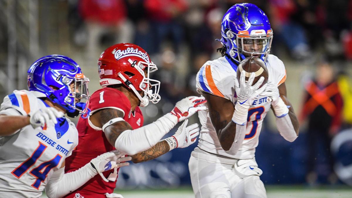Former Boise State safety JL Skinner, right, intercepts a pass intended for Fresno State’s Keric Wheatfall during a game in Fresno, California, in 2021. Skinner became the latest Bronco to hear his name called in the NFL Draft on Saturday.
